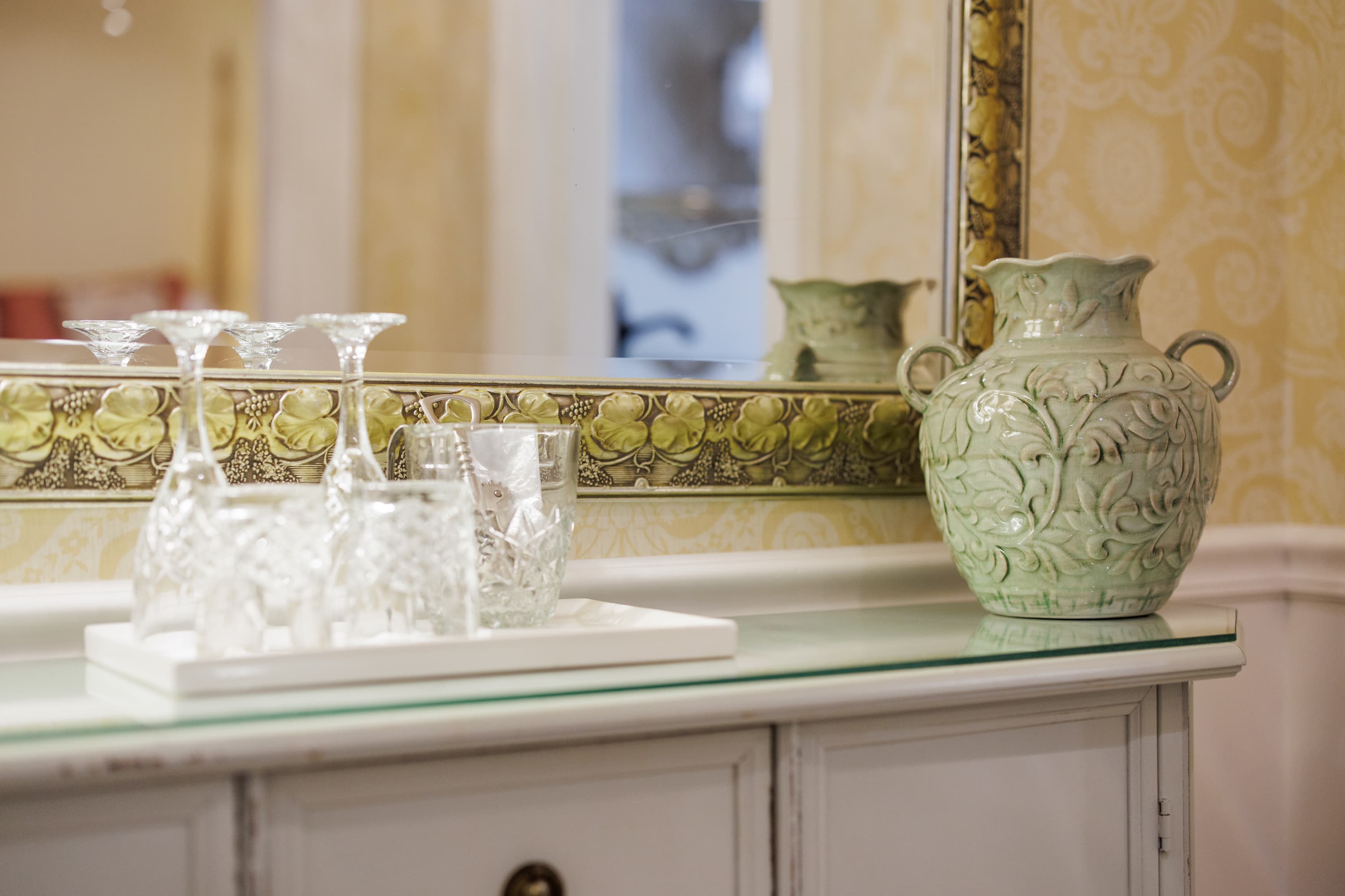 green vase and glassware